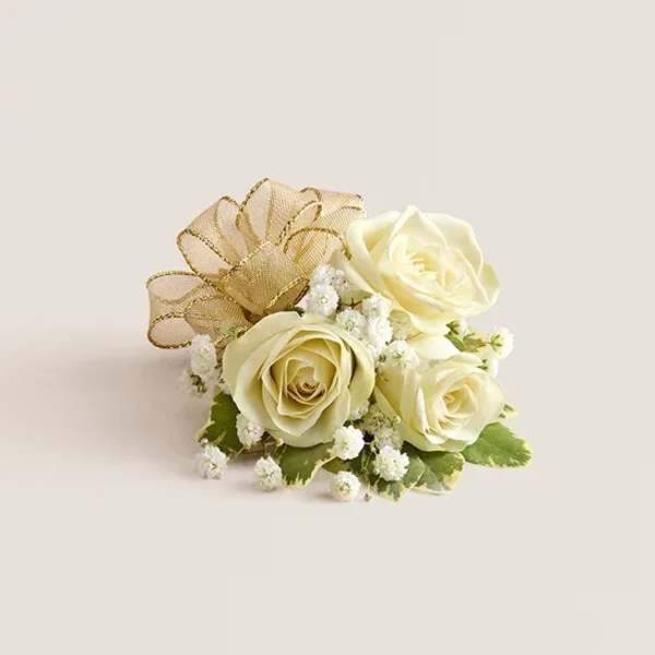 Small cream rose arrangement with gold ribbon and white filler flowers