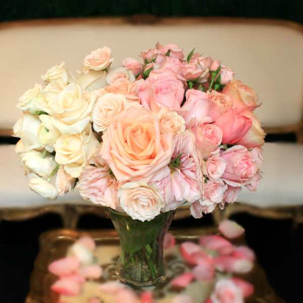 Bouquet of pale pink and cream roses in a clear glass vase