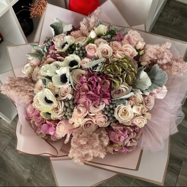 Large bouquet of blush roses, pink hydrangeas, and white anemones