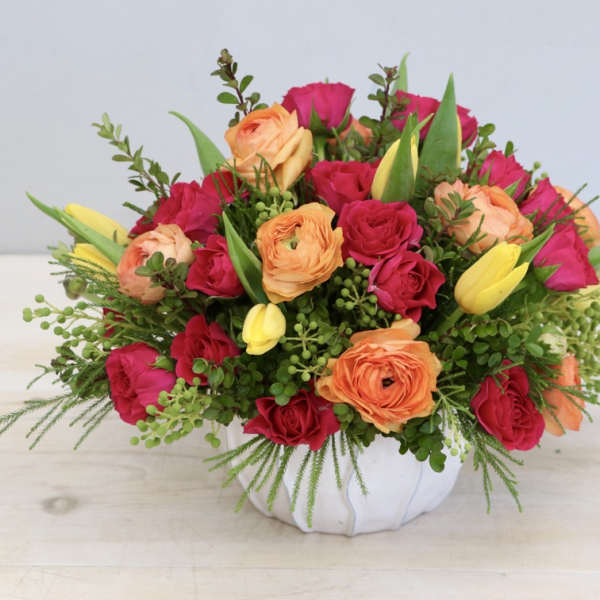 Mixed roses and tulips in a white vase