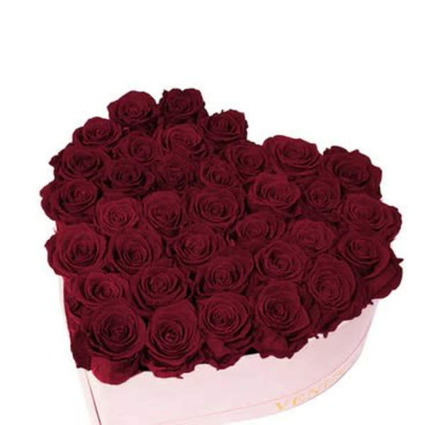 Heart-shaped box filled with dark red roses
