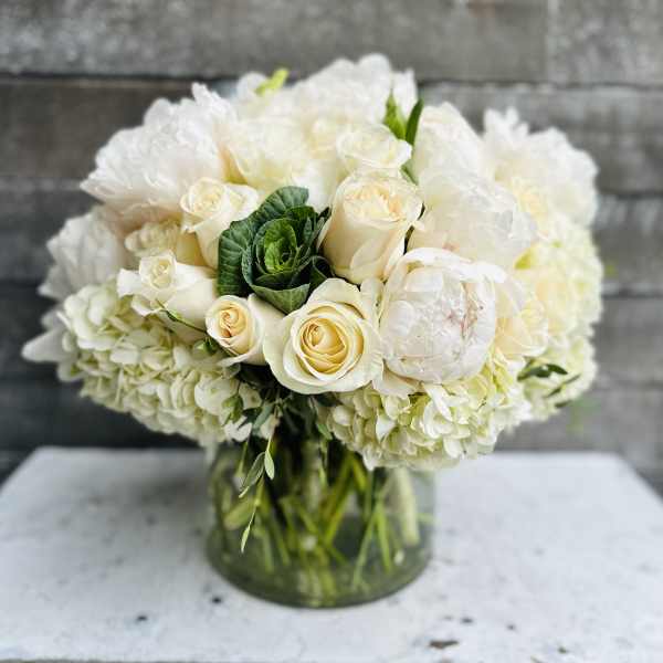 White rose and hydrangea bouquet in a glass vase