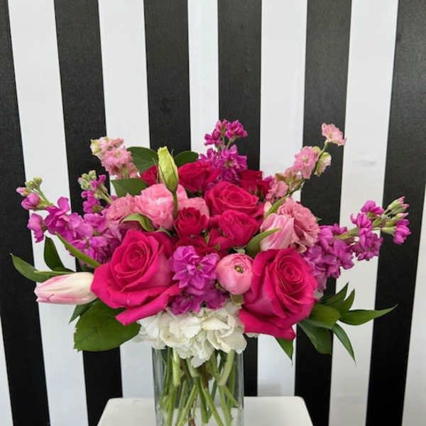 Pink and purple mixed bouquet in a clear glass vase