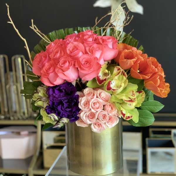 Colorful rose arrangement in a gold vase