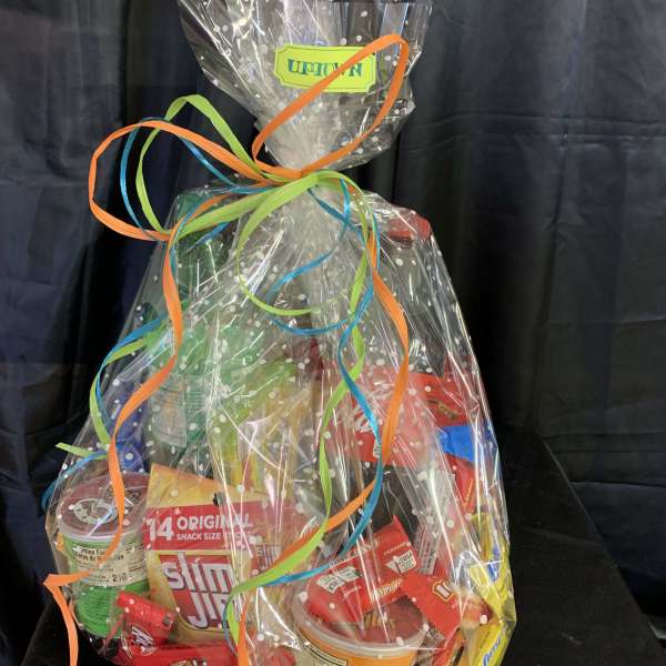Cellophane-wrapped snack gift basket with colorful ribbon