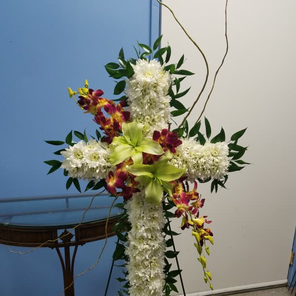 Cross-shaped floral standing spray with white chrysanthemums and green orchids