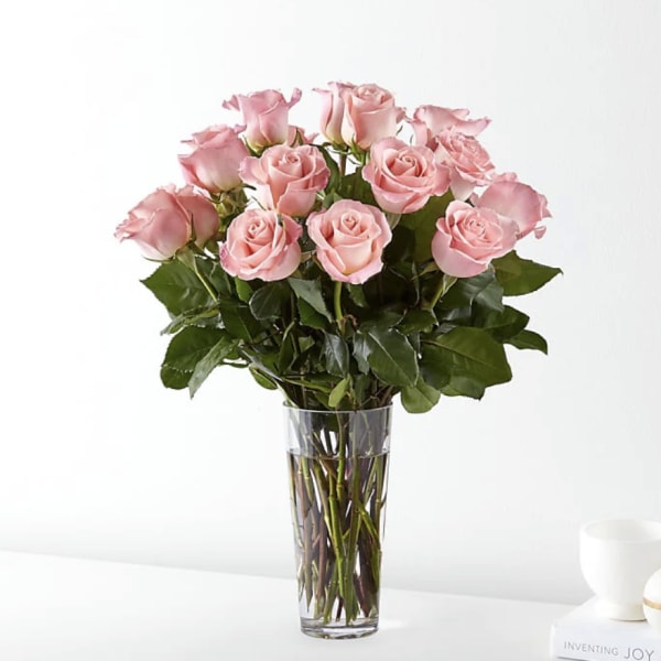Pink roses arranged in a clear glass vase