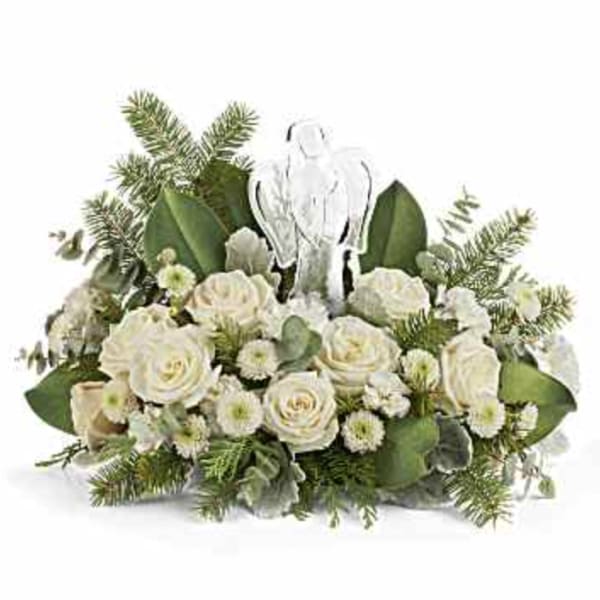 White rose arrangement with evergreen foliage and a clear angel ornament
