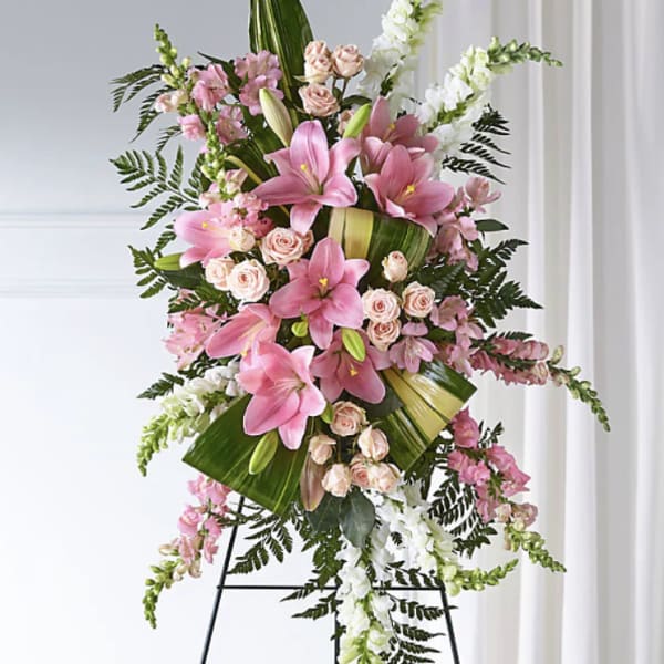 Pink lilies and roses arranged on a standing easel