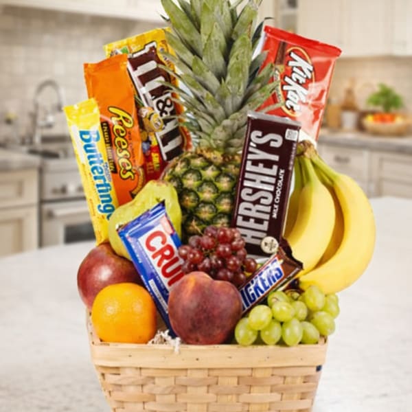 Fruit basket with candy bars and bananas in a woven basket