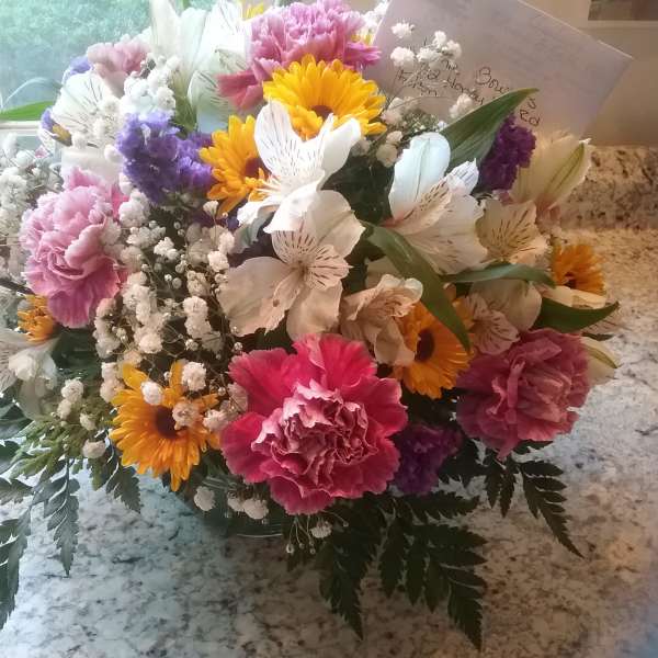 Mixed bouquet of carnations, daisies, and alstroemeria in a vase