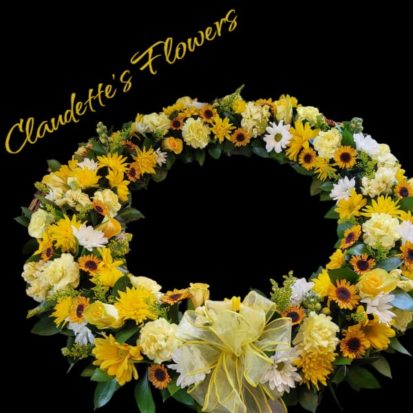 Yellow and white floral wreath with a ribbon bow