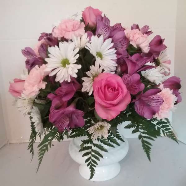 Pink and white mixed flower arrangement in a white vase
