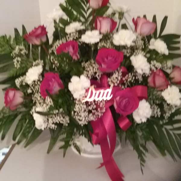 Pink and white rose arrangement with a ribbon and "Dad" sign