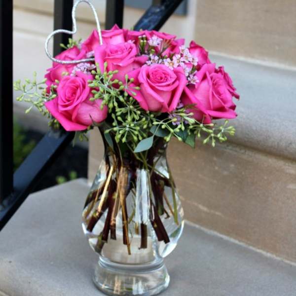 Pink roses arranged in a clear glass vase