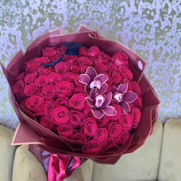 Large bouquet of hot pink roses with a few orchid blooms