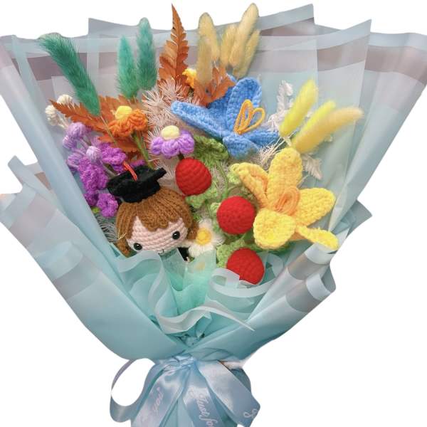 Crocheted bouquet with a doll face and colorful yarn flowers wrapped in blue paper