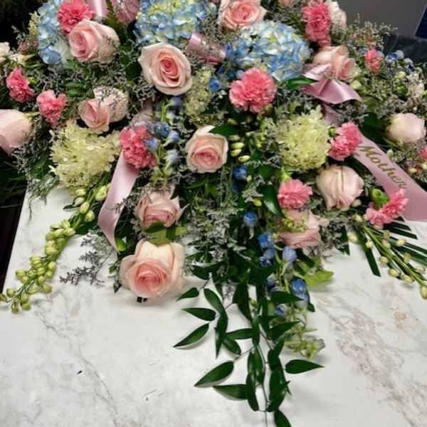 Large pastel floral spray with pink roses and blue hydrangeas