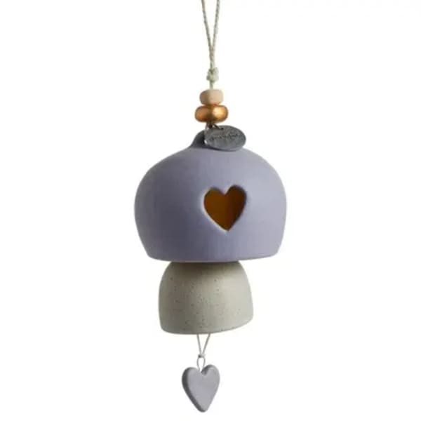 Hanging ceramic ornament with a heart cutout and dangling heart charm