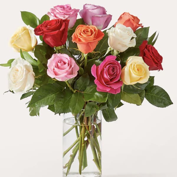 Bouquet of multicolored roses in a clear glass vase