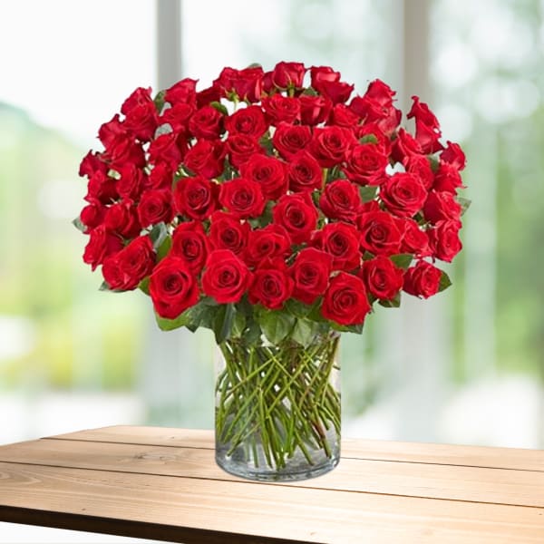Large bouquet of red roses in a clear glass vase