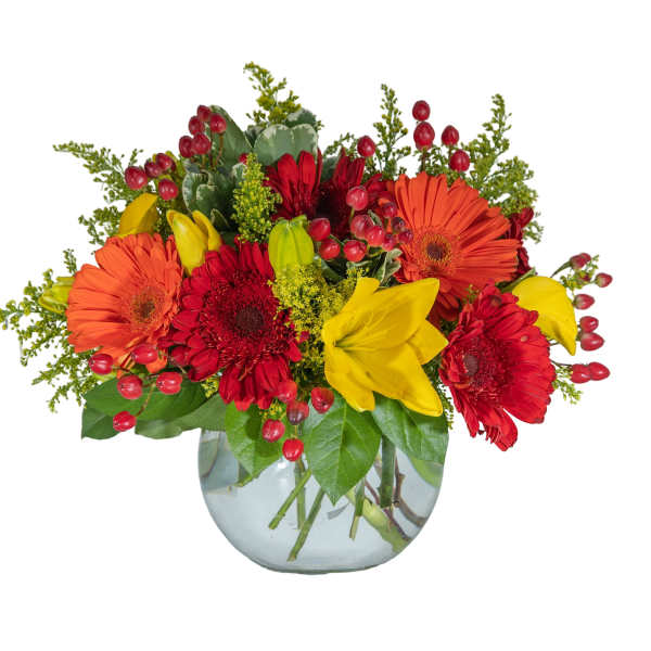 Bright mixed bouquet of red, orange, and yellow flowers in a glass vase