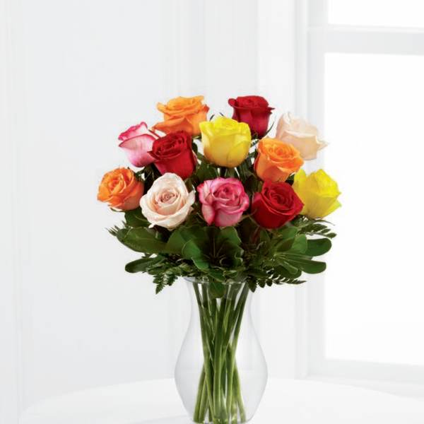 Mixed-color roses arranged in a clear glass vase