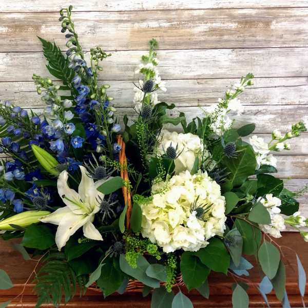 Blue and white floral arrangement in a basket
