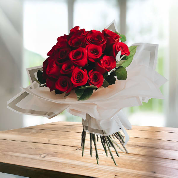 Bouquet of red roses wrapped in white paper