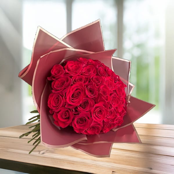 Bouquet of red roses wrapped in pink paper