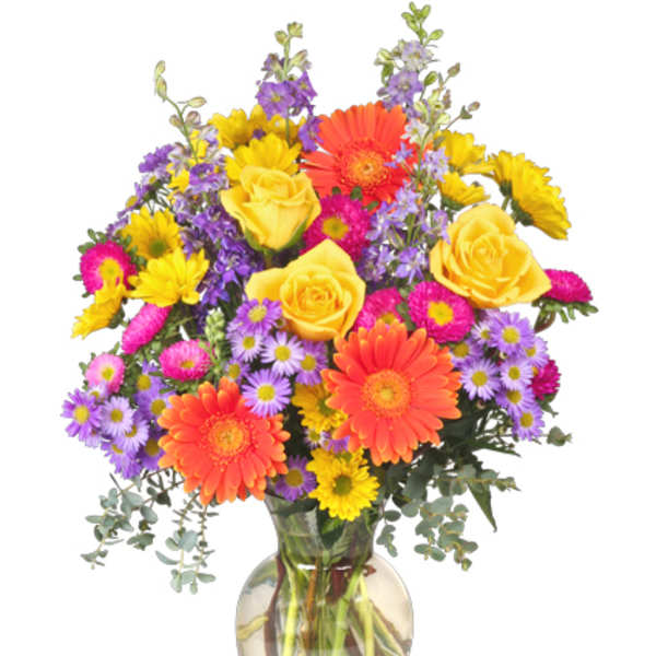 Colorful bouquet of yellow roses, orange gerberas, and purple daisies in a glass vase