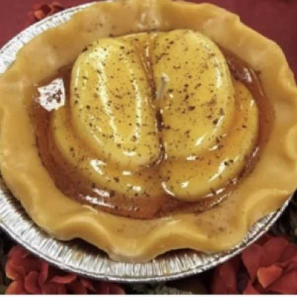Foil pan holding a yellow molded dessert with a glossy topping