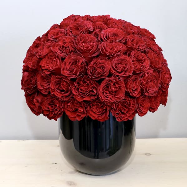 Red rose bouquet in a black vase