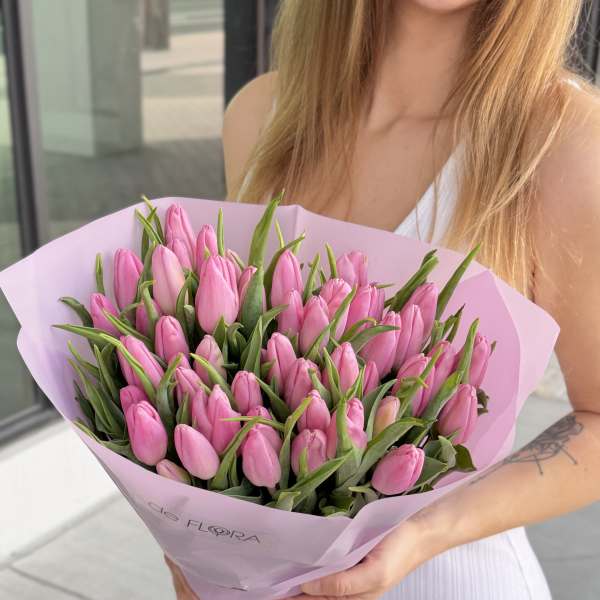 Bouquet of pink tulips wrapped in light pink paper