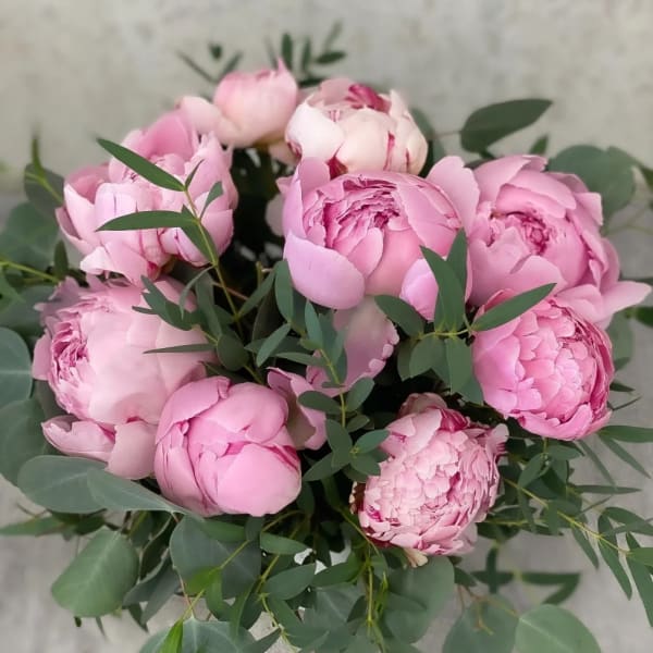 Bouquet of pink peonies with eucalyptus foliage