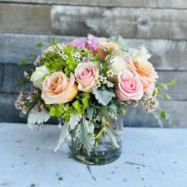 Bouquet of pastel roses in a clear glass vase