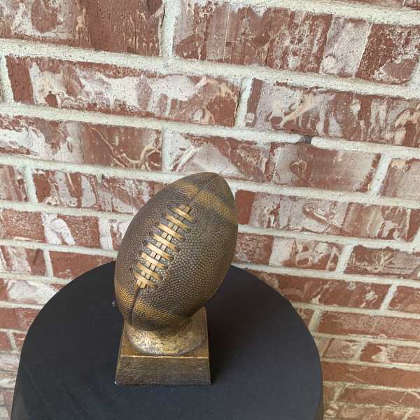 Bronze football sculpture on a square base