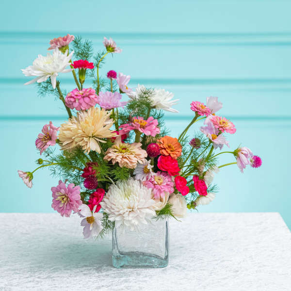 Mixed pink and white flowers in a clear glass vase