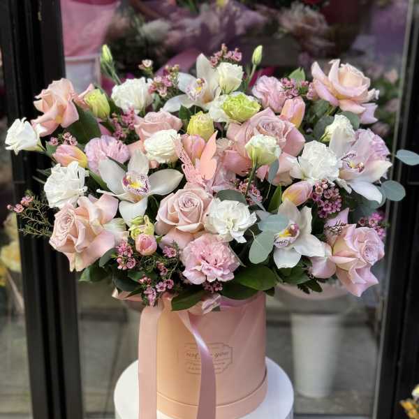 Blush and white bouquet in a pink hatbox with ribbon