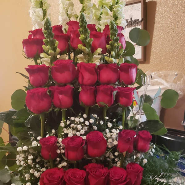 Tiered bouquet of red roses with white snapdragons and baby's breath