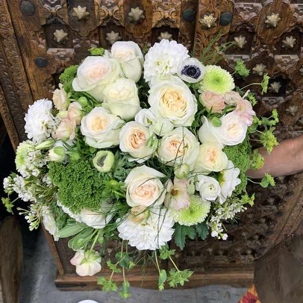 White and pale peach bouquet with green accents