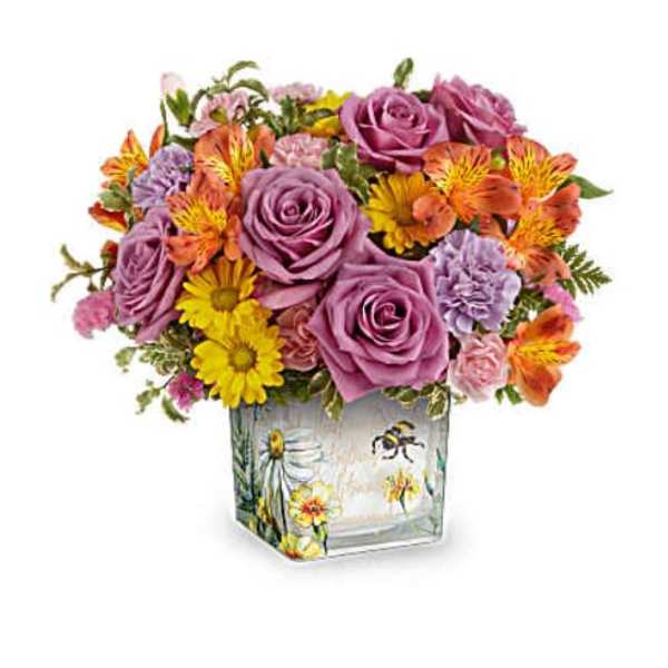 Bouquet of purple roses and mixed daisies in a painted glass vase