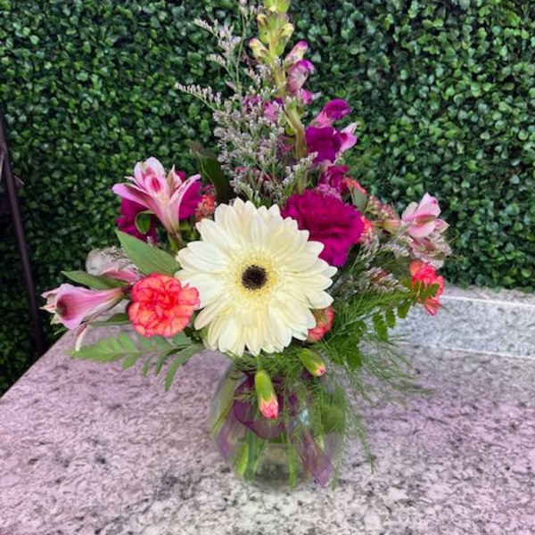 Mixed pink and white flowers in a glass vase