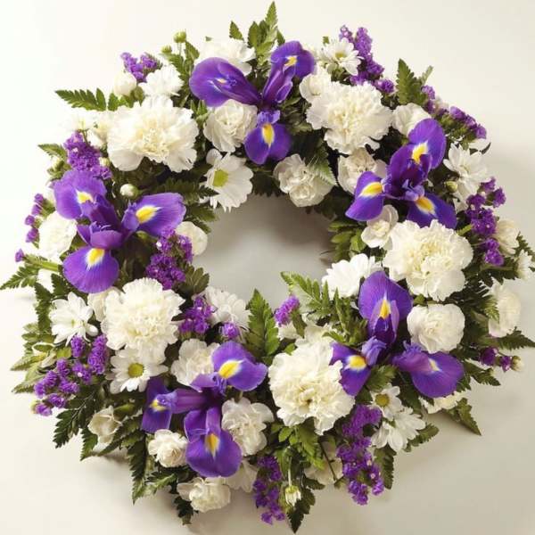 Circular floral wreath with white blooms and purple irises