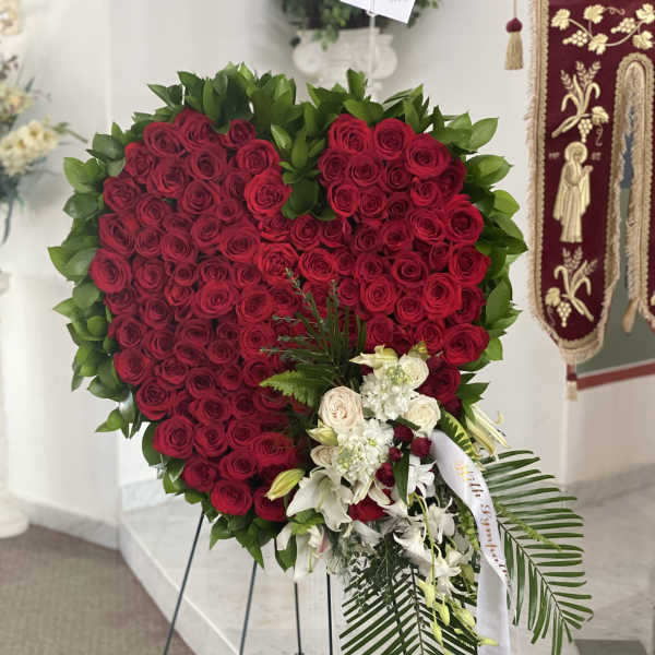 Heart-shaped red rose standing spray with white flowers and greenery