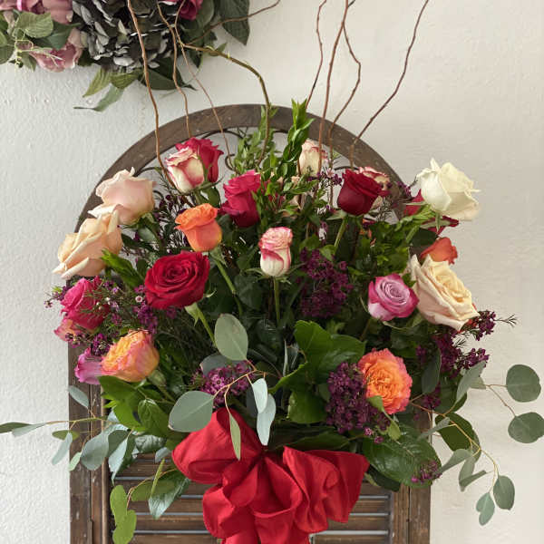 Mixed rose bouquet with a large red ribbon bow