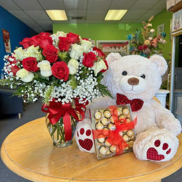 Red and white rose bouquet with a teddy bear and chocolates