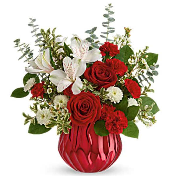 Red roses and white lilies in a red glass vase