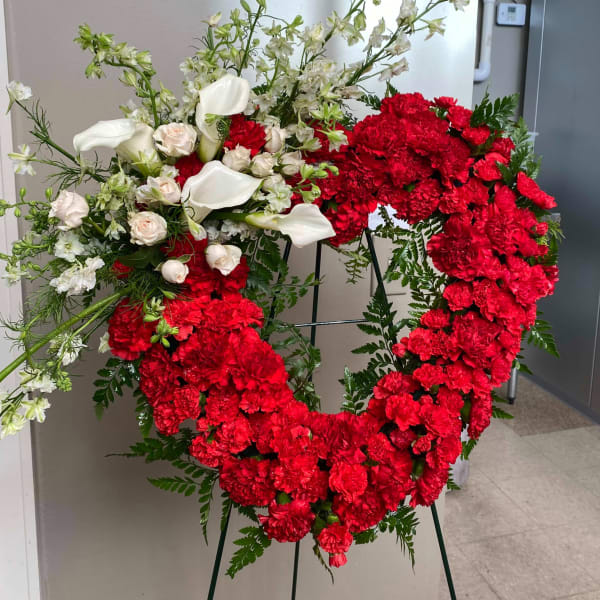 Heart-shaped red carnation wreath with white calla lilies and roses