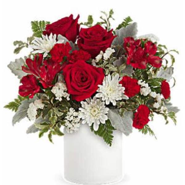 Red roses and white daisies in a white vase